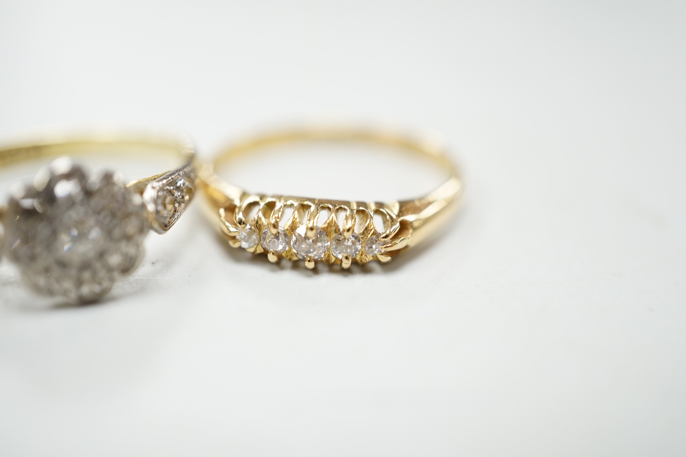 Three assorted 18ct and diamond cluster set rings including a late Victorian five stone diamond chip half hoop, gross weight 7.9 grams.
